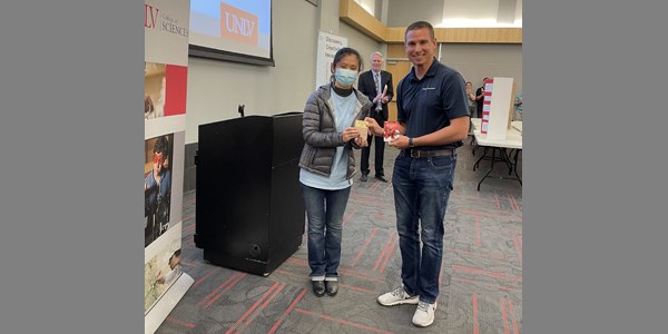 Garrett Wake presents Anya Zhang with the “Exceptional Earth Science Project” award for an outstanding earth science project at the Beal Bank Science Fair, Las Vegas, NV. Photo taken on 3/22/2022.